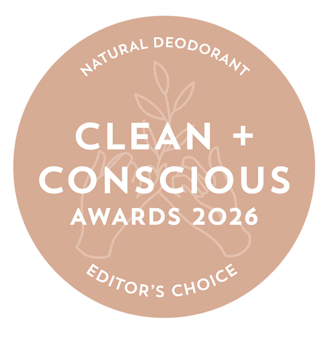 A circular award badge in muted peach with white text reading 'NATURAL DEODORANT', 'CLEAN + CONSCIOUS AWARDS 2026', and 'EDITOR'S CHOICE'.