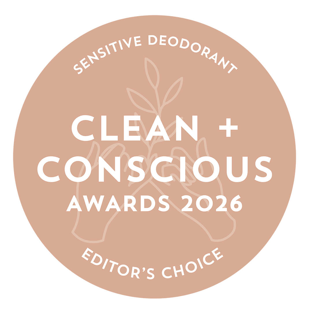 A circular beige award badge reading 'SENSITIVE DEODORANT', 'CLEAN + CONSCIOUS AWARDS 2026', and 'EDITOR'S CHOICE' in white text, with a faint botanical and hands illustration in the center on a white background.